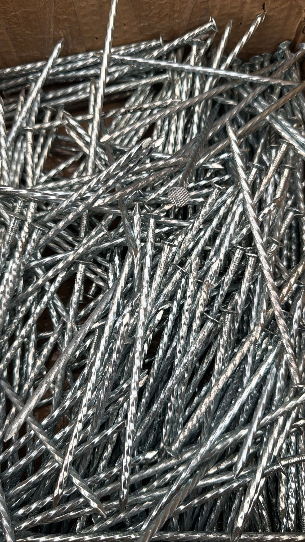 Durable 6-inch steel nails with strong holding power, ideal for construction and landscaping tasks like securing wood and fencing.