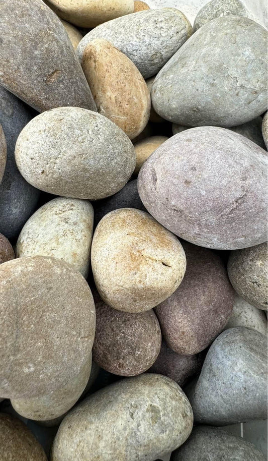 Vibrant, decorative stones that feature a beautiful mix of colors, reminiscent of the lush landscapes and diverse flora of the Amazon rainforest. These pebbles are smooth, rounded, and vary in shades, including rich greens, earthy browns, soft yellows, and hints of reds, oranges, and blues, creating a striking, natural appearance. 