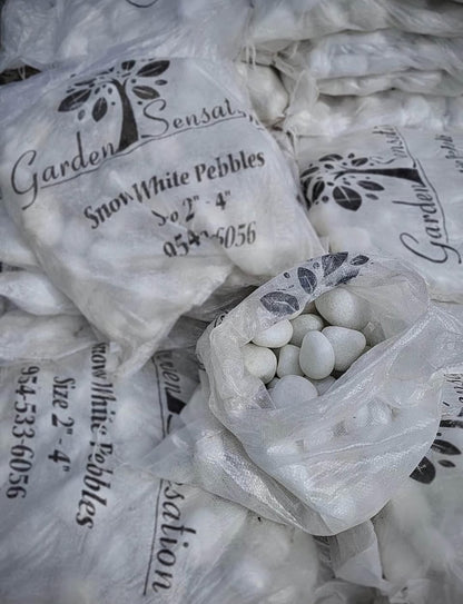 These smooth white stones are perfect for adding a clean, elegant look to any garden, pathway, or water feature. Their bright color provides a stunning contrast to greenery and flowers, making them ideal for both decorative and functional landscaping projects. 